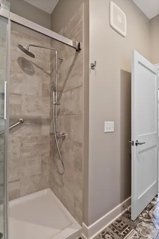 a bathroom with a glass shower door