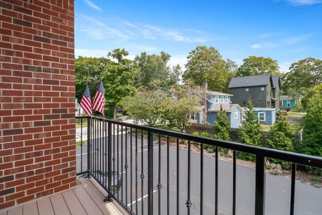 a view of a big house with a big yard and large trees