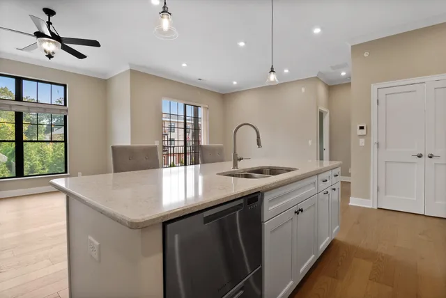 a kitchen with center island a sink stainless steel appliances and window
