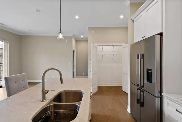 a kitchen with a refrigerator and a sink