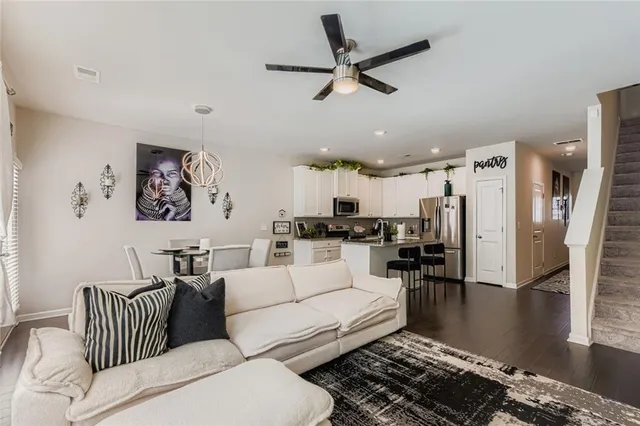 a living room with furniture and kitchen view