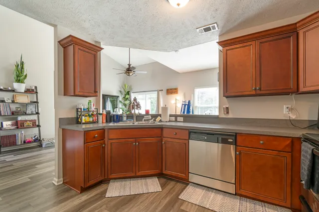a kitchen with wooden cabinets and sink