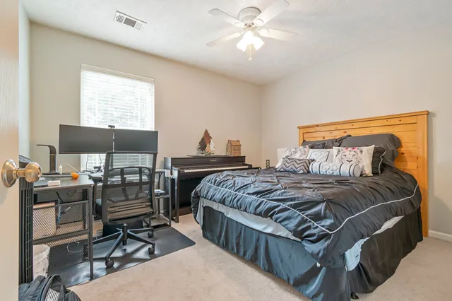 a bedroom with a bed and a desk