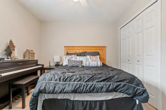 a bedroom with a bed and a potted plant
