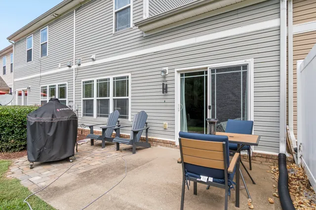 a view of a two chairs in the back yard