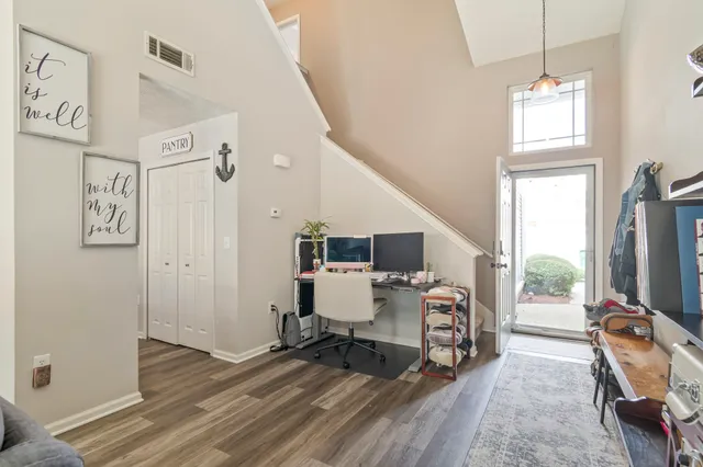 a room with furniture a flat screen tv and a window