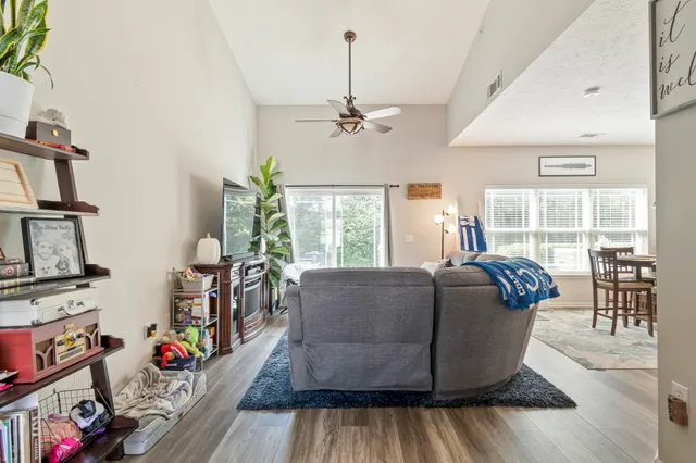 a living room with furniture fireplace and a window