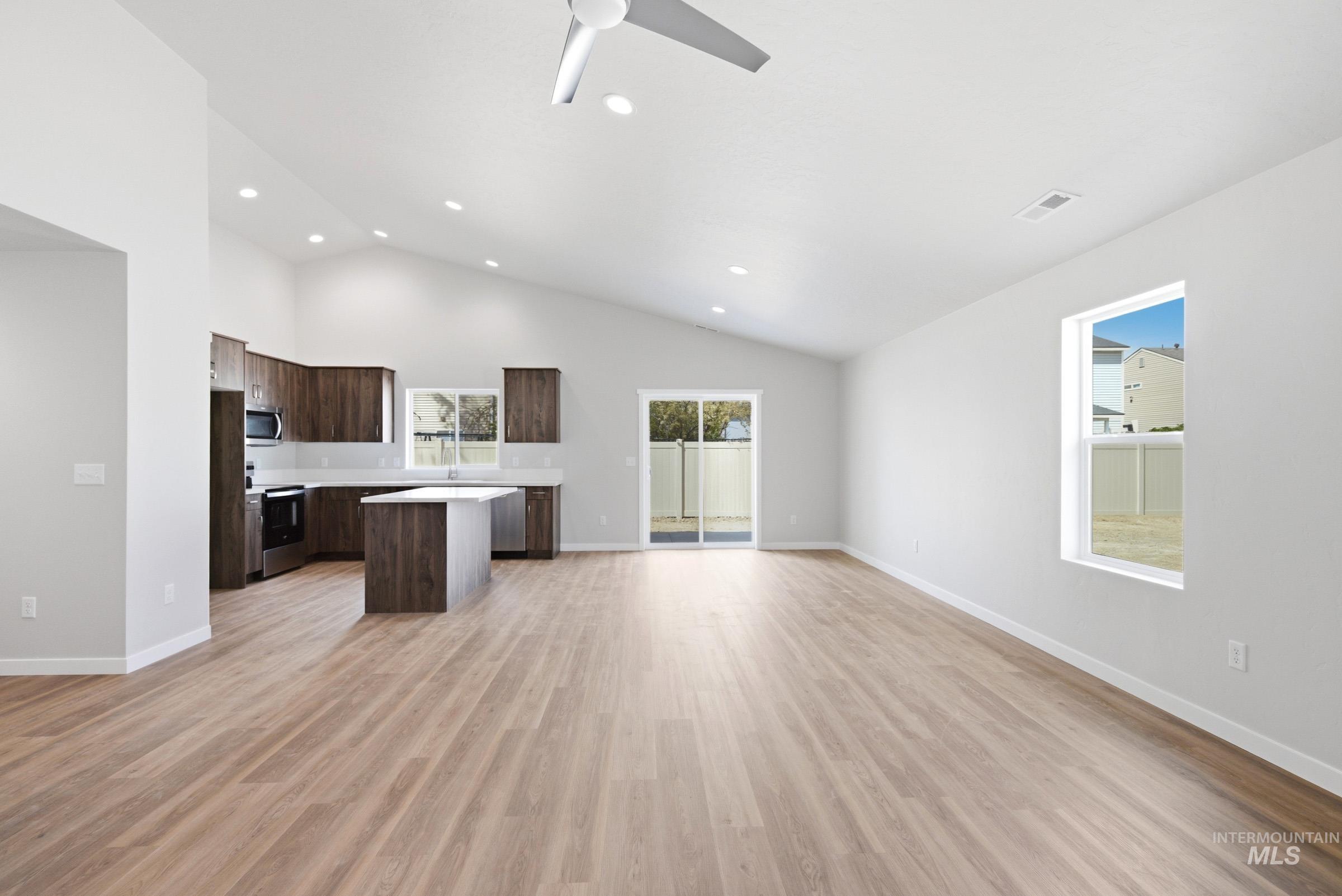13734 Redway Court Caldwell, ID 83607 - Photo 20 of 20 Kitchen with open floor plan, light countertops, a center island, dark wood finish cabinetry, and ceiling fan