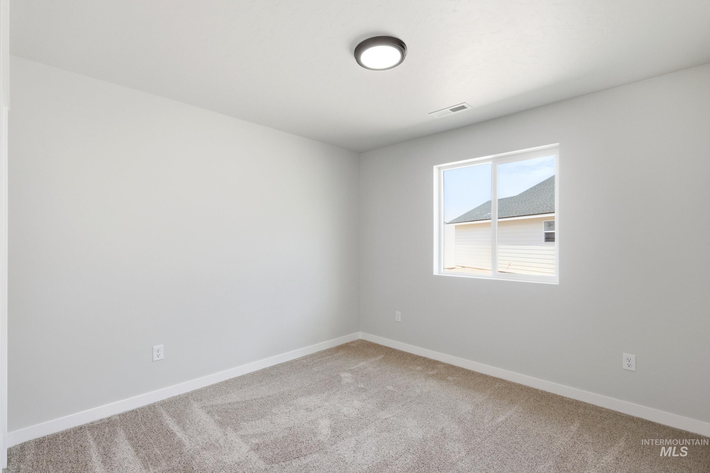 13734 Redway Court Caldwell, ID 83607 - Photo 12 of 20 Empty room featuring light carpet and baseboards