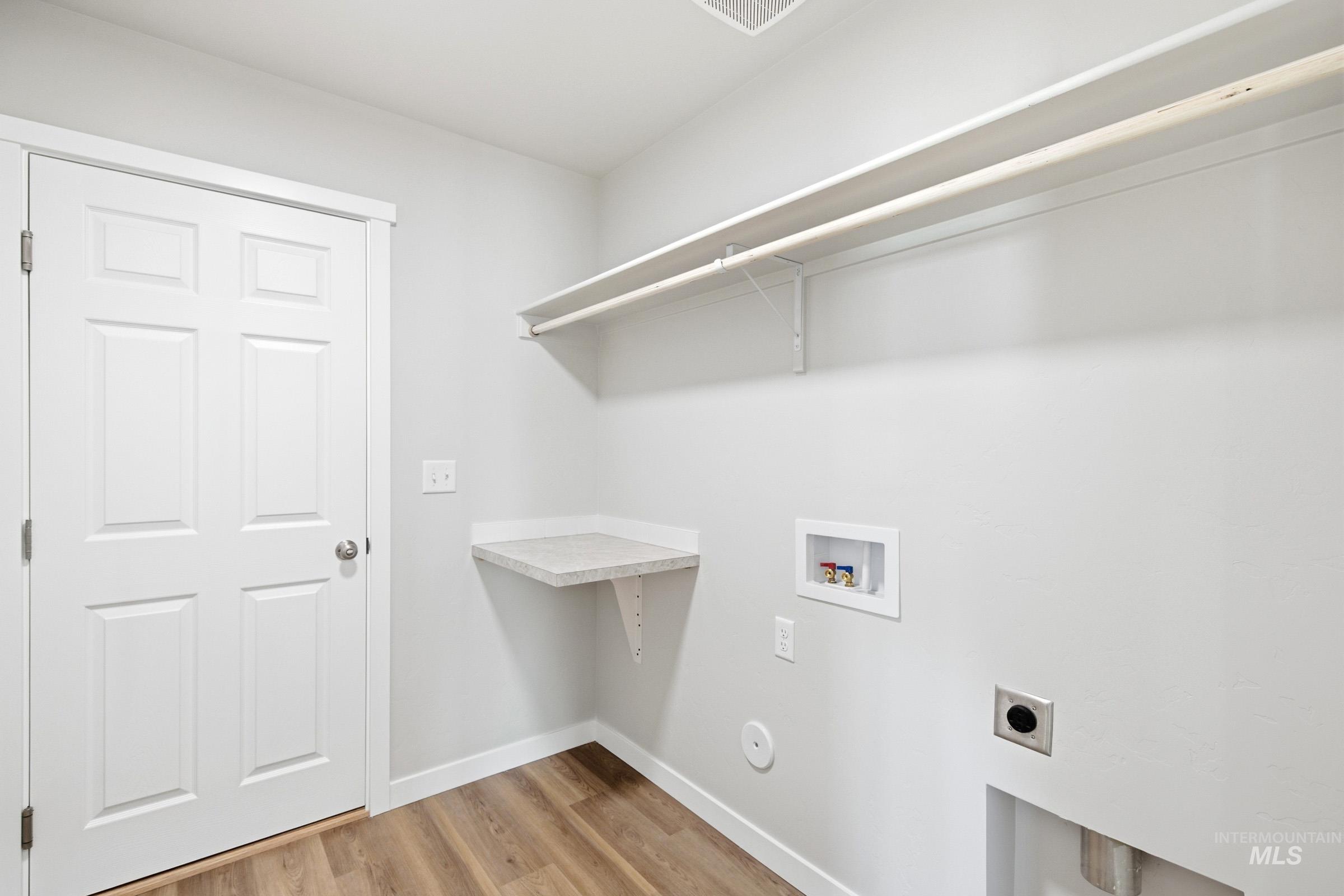 13734 Redway Court Caldwell, ID 83607 - Photo 14 of 20 Laundry room with light wood-style flooring, hookup for a washing machine, and hookup for an electric dryer