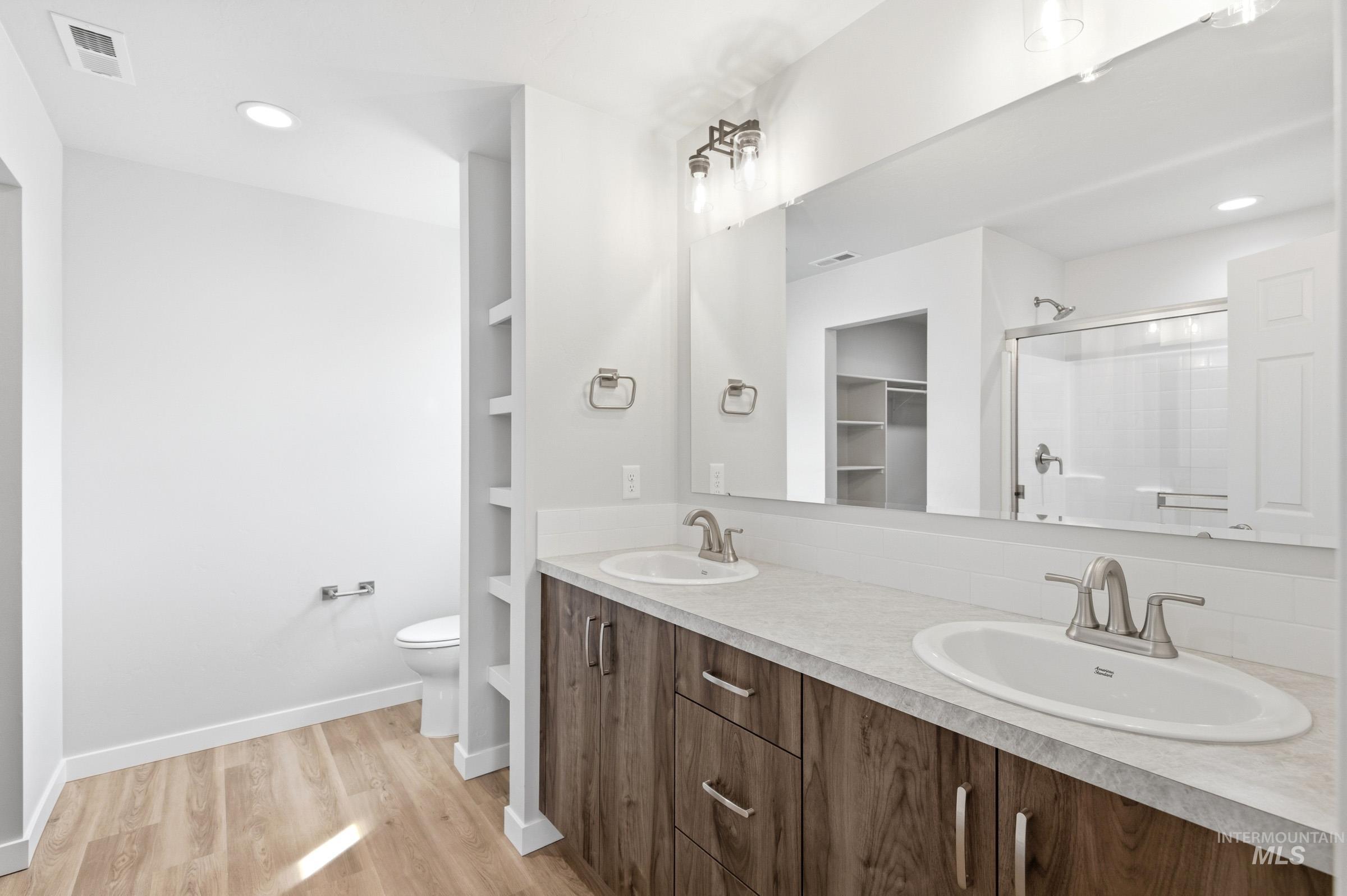 13734 Redway Court Caldwell, ID 83607 - Photo 17 of 20 Bathroom with double vanity, recessed lighting, a stall shower, light wood finished floors, and a spacious closet