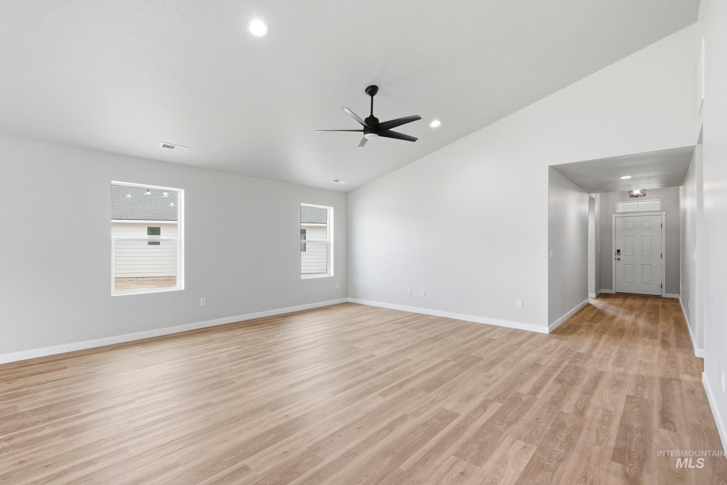 13734 Redway Court Caldwell, ID 83607 - Photo 9 of 20 Unfurnished room with ceiling fan, vaulted ceiling, light wood-type flooring, and recessed lighting