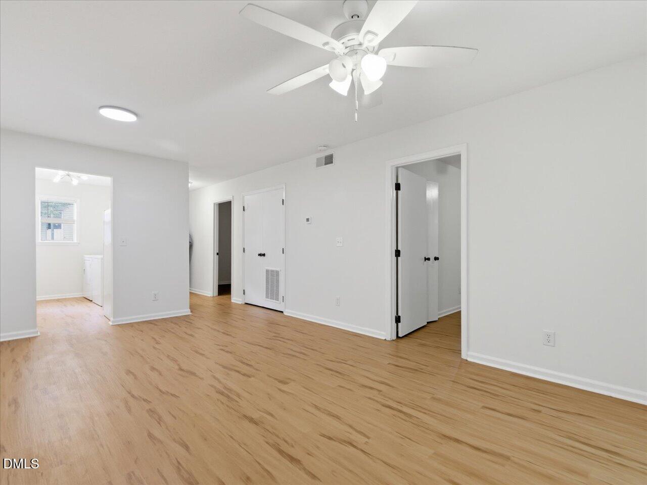 332 Ashley Forest Road Chapel Hill, NC 27514 - Photo 12 of 44 an empty room with wooden floor and ceiling fan