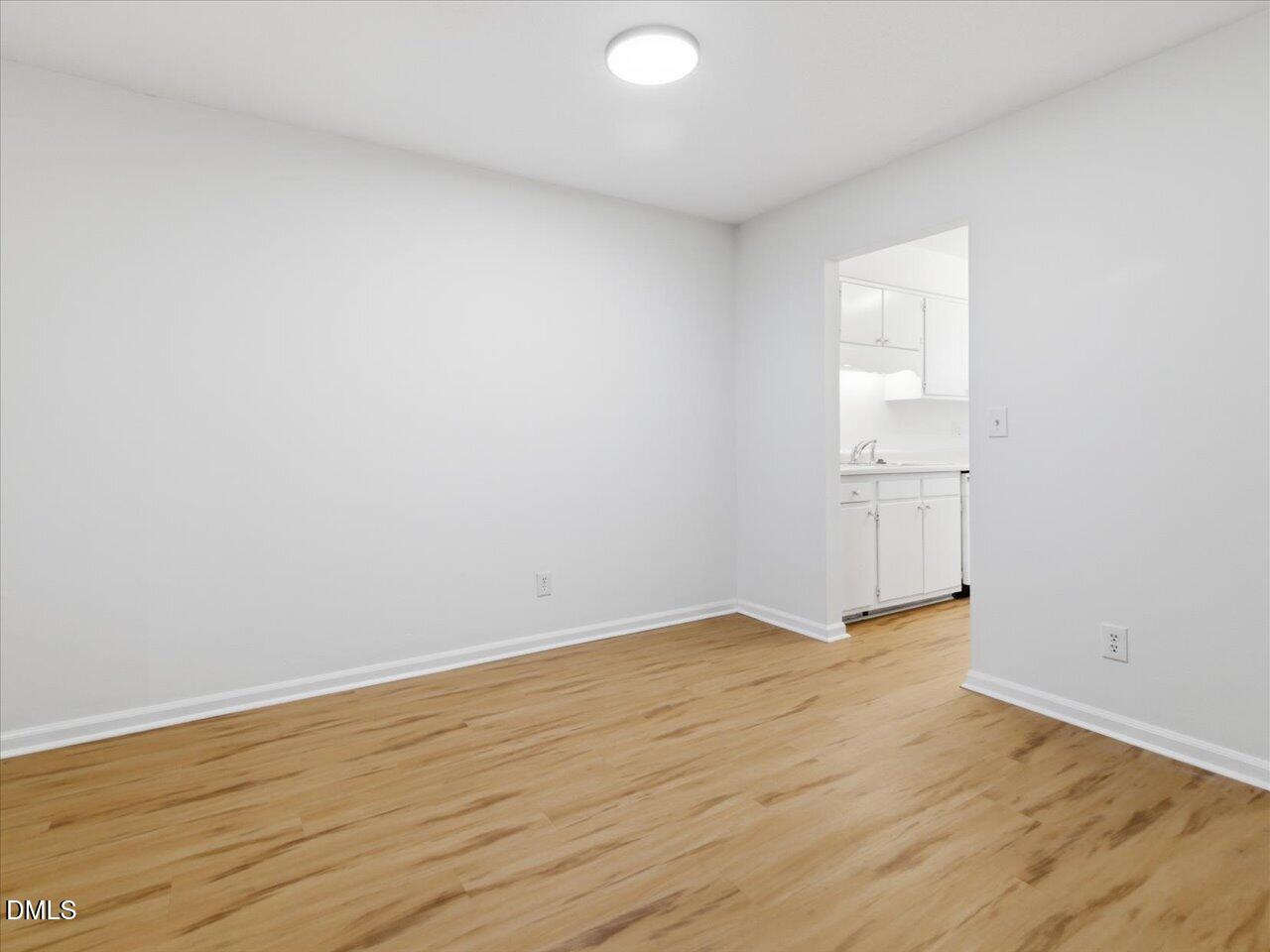 332 Ashley Forest Road Chapel Hill, NC 27514 - Photo 14 of 44 an empty room with wooden floor and windows