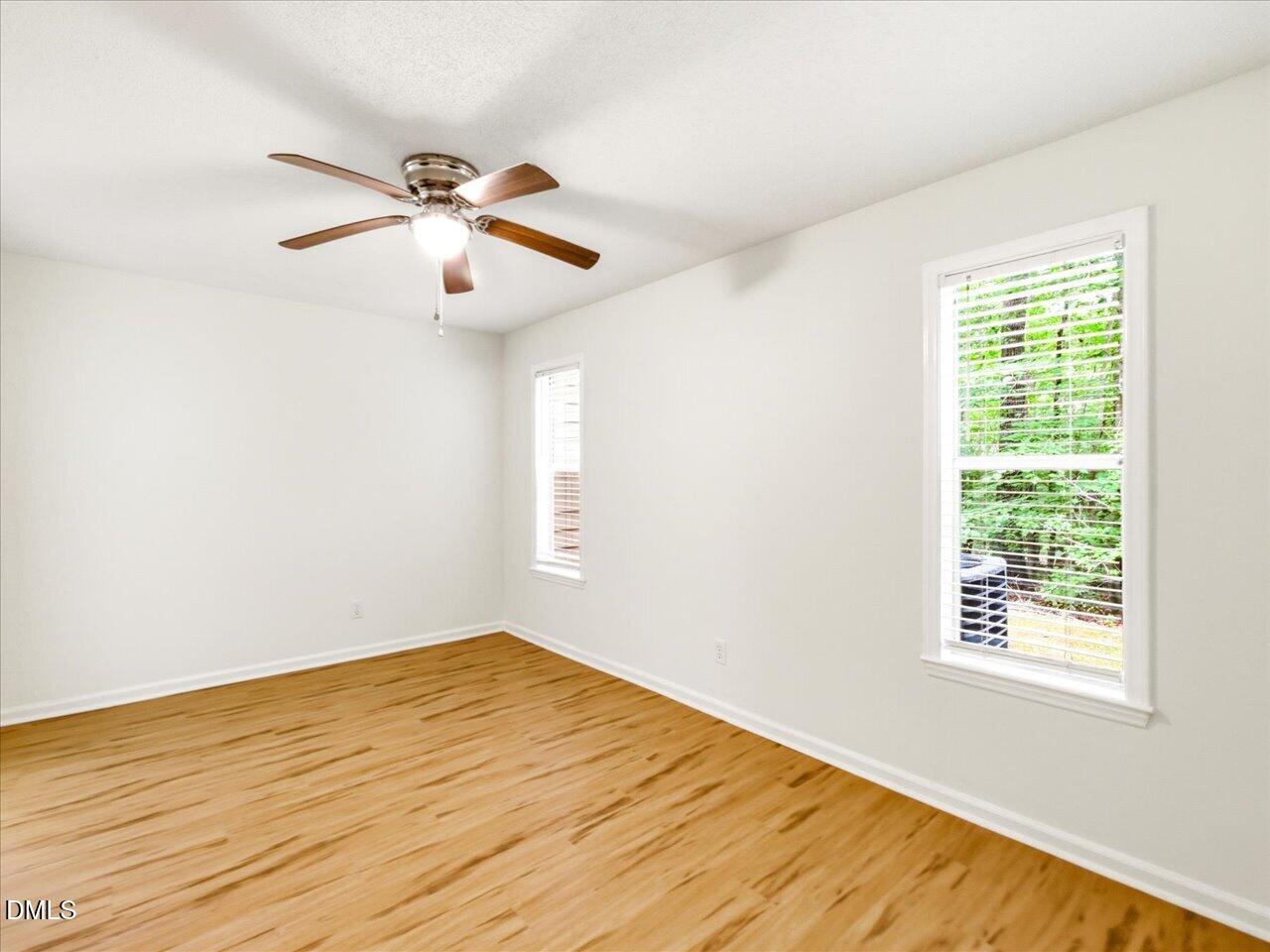 332 Ashley Forest Road Chapel Hill, NC 27514 - Photo 21 of 44 a view of empty room with wooden floor and fan