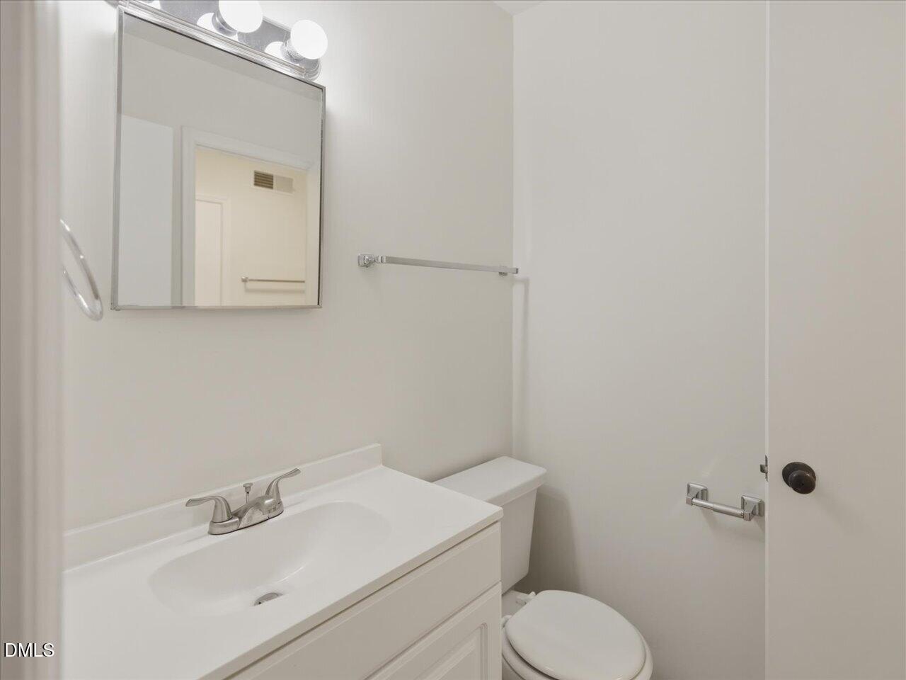 332 Ashley Forest Road Chapel Hill, NC 27514 - Photo 28 of 44 a bathroom with a toilet sink and mirror