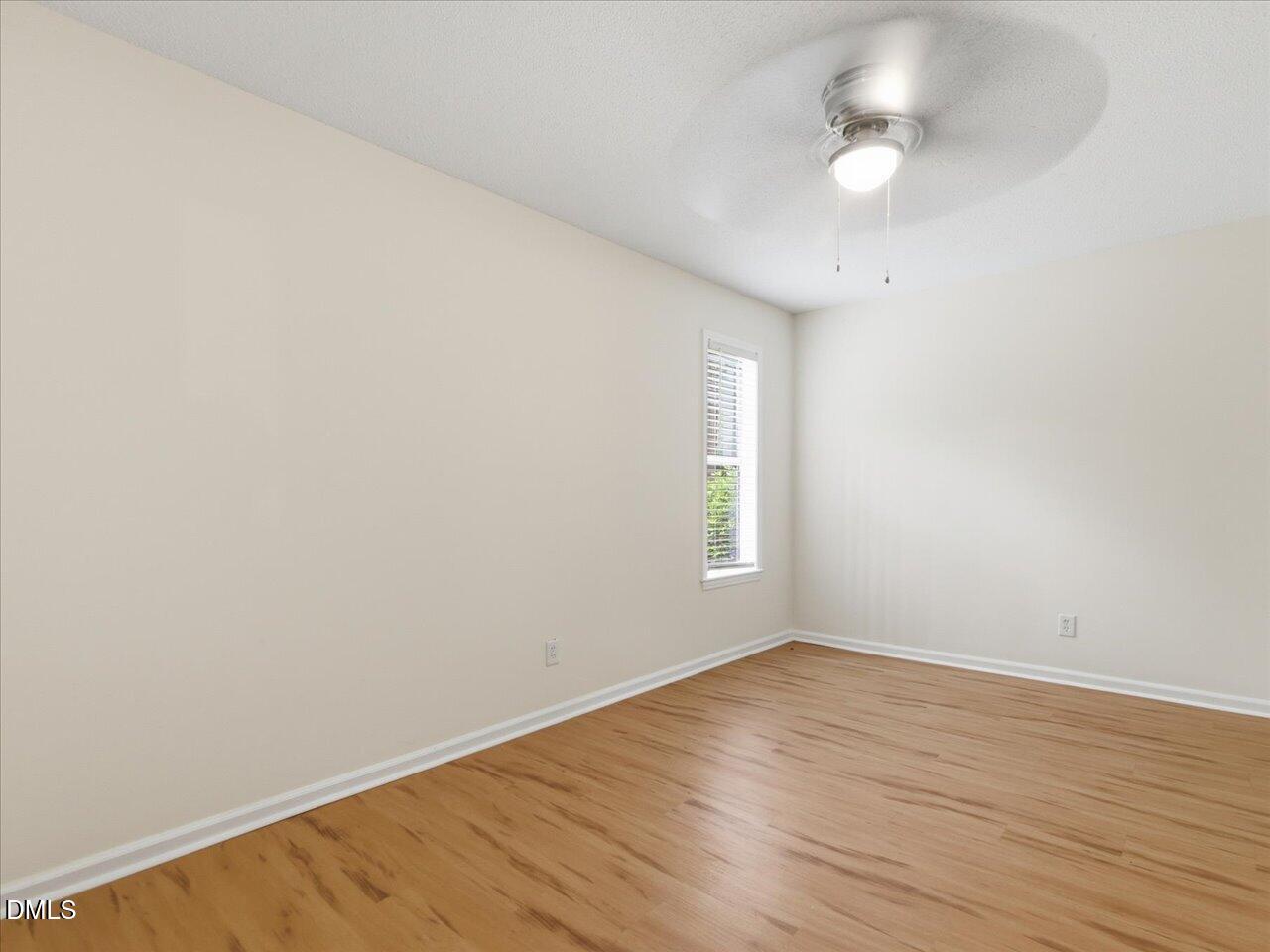 332 Ashley Forest Road Chapel Hill, NC 27514 - Photo 29 of 44 an empty room with wooden floor and windows