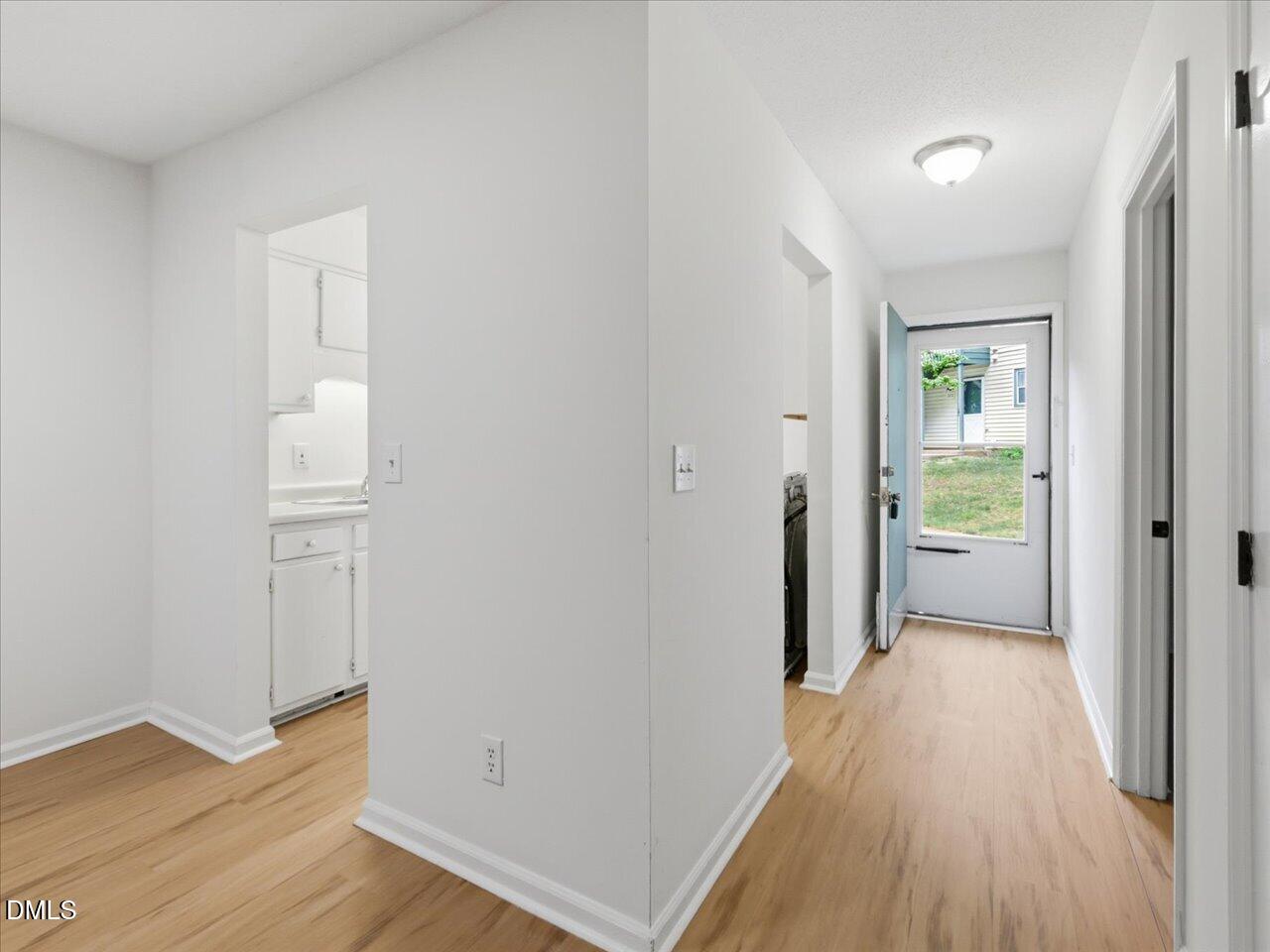 332 Ashley Forest Road Chapel Hill, NC 27514 - Photo 5 of 44 a view of a hallway with wooden floor and a bathroom