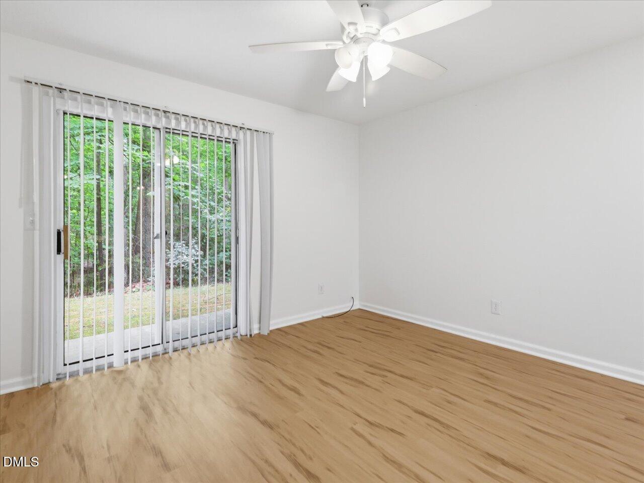 332 Ashley Forest Road Chapel Hill, NC 27514 - Photo 7 of 44 a view of an empty room with wooden floor and a window