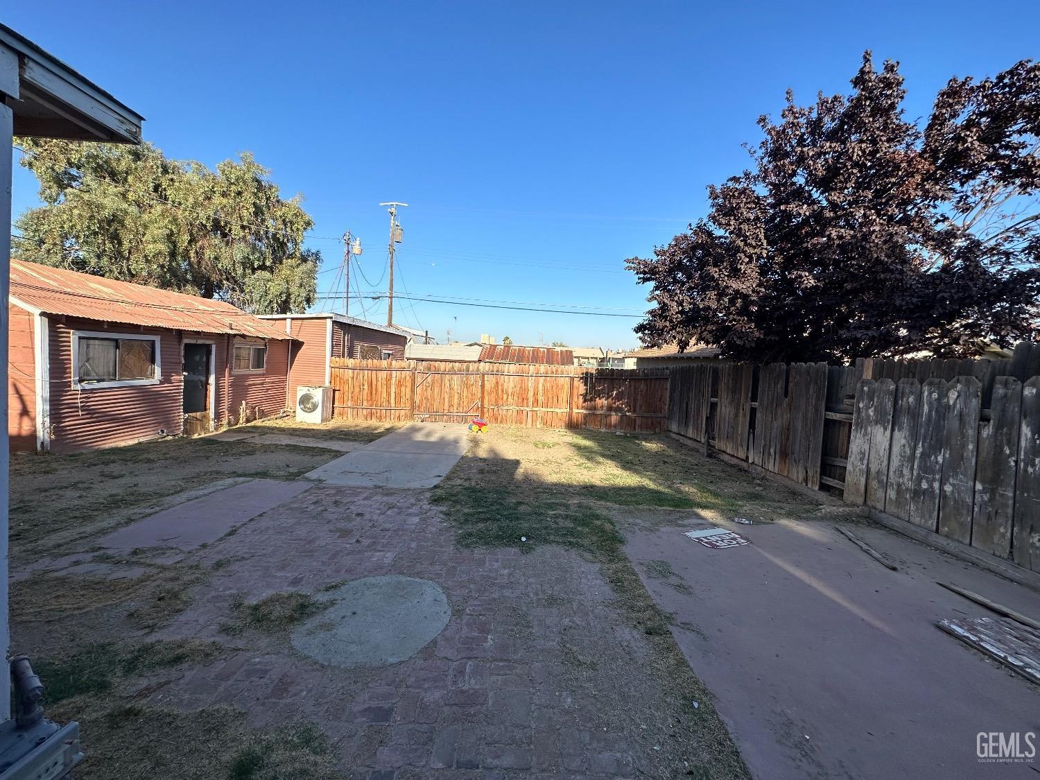 Undisclosed Address Taft, CA 93268 - Photo 17 of 22 a view of a house with backyard and trees