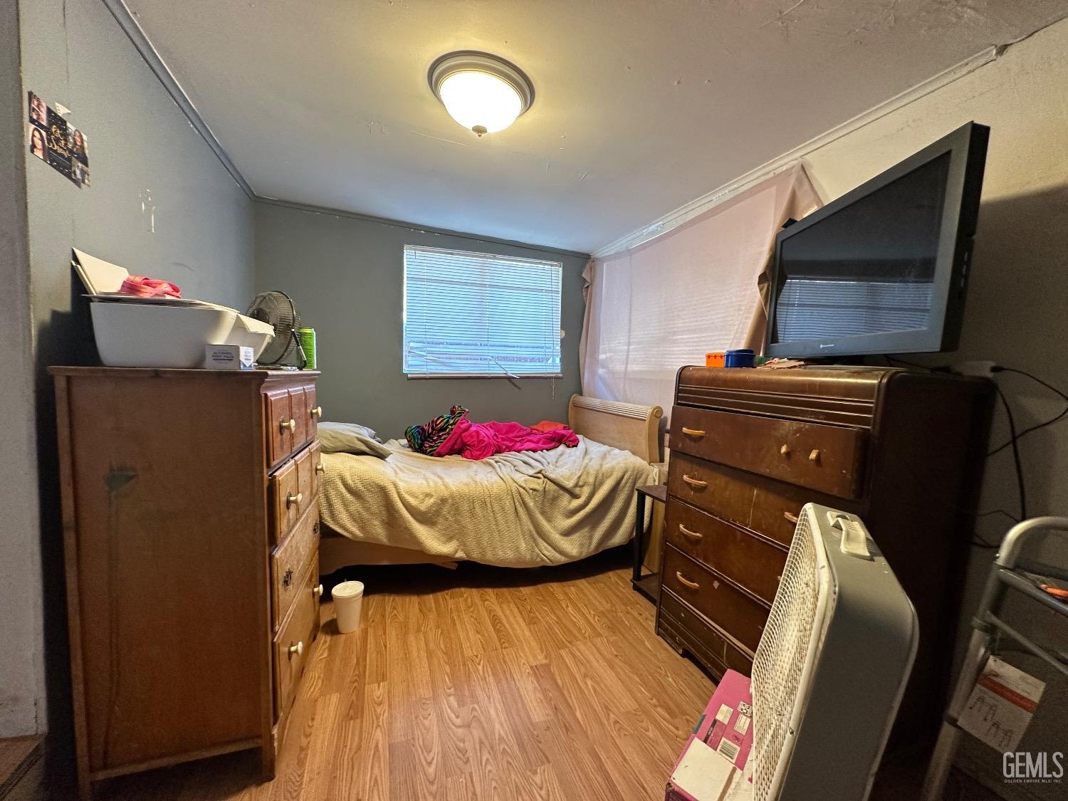 Undisclosed Address Taft, CA 93268 - Photo 9 of 22 a bedroom with a bed and wooden floor