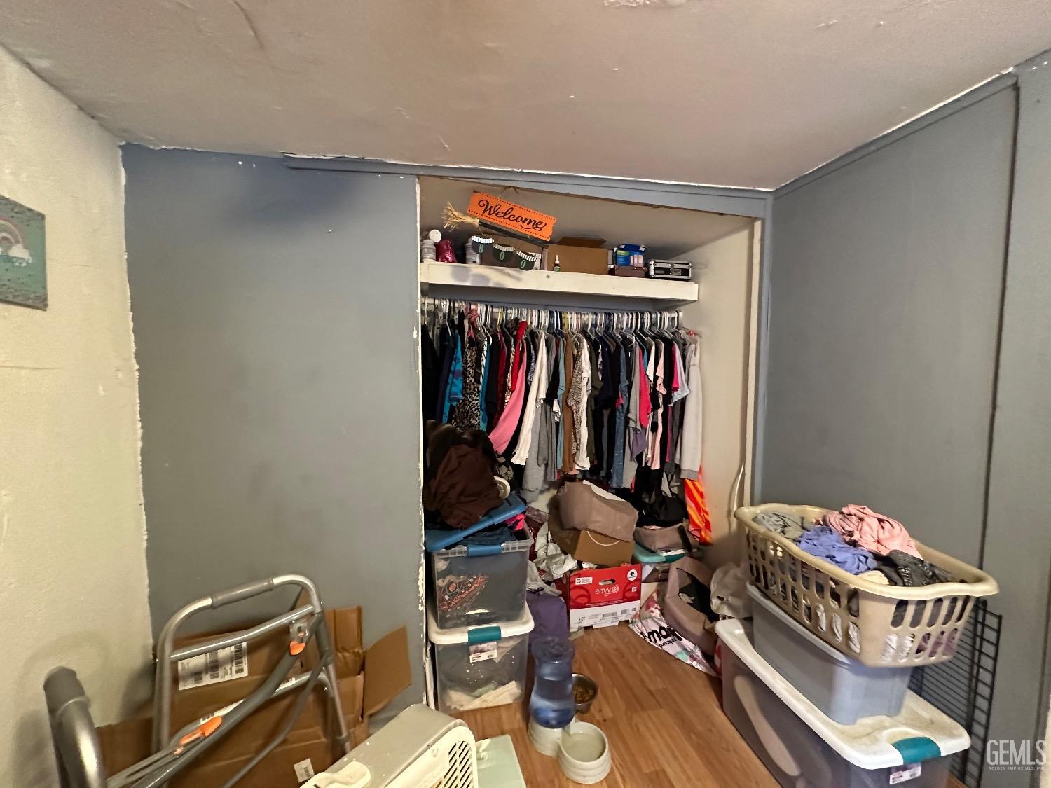 Undisclosed Address Taft, CA 93268 - Photo 10 of 22 a view of walk in closet with clothes and shoes