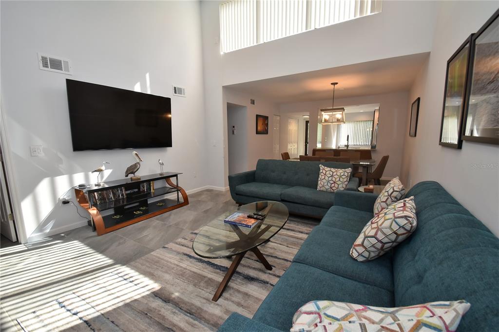 1508 Pelican Cove Road, Unit GR233 Sarasota, FL 34231 - Photo 11 of 37 a living room with furniture and a flat screen tv