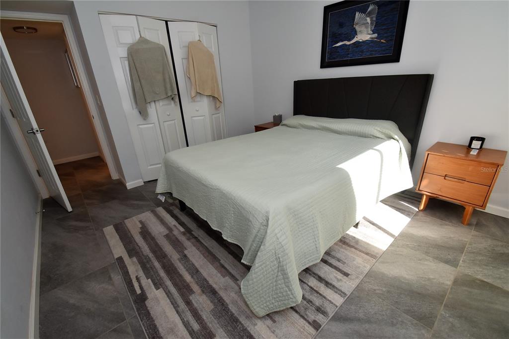 1508 Pelican Cove Road, Unit GR233 Sarasota, FL 34231 - Photo 16 of 37 a bedroom with a bed and a rug