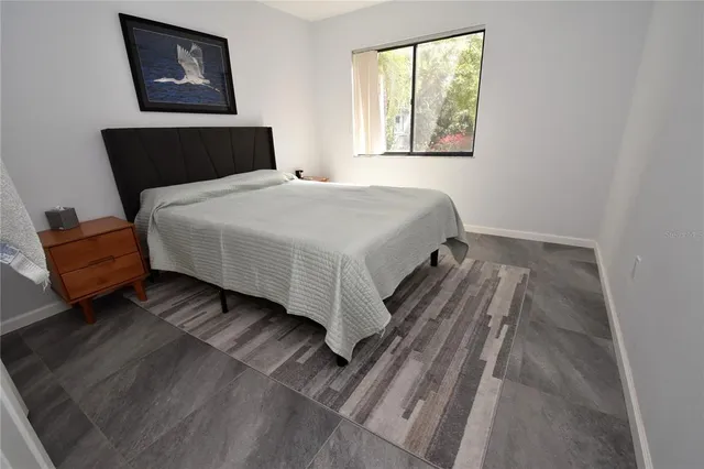 a bedroom with a bed and window