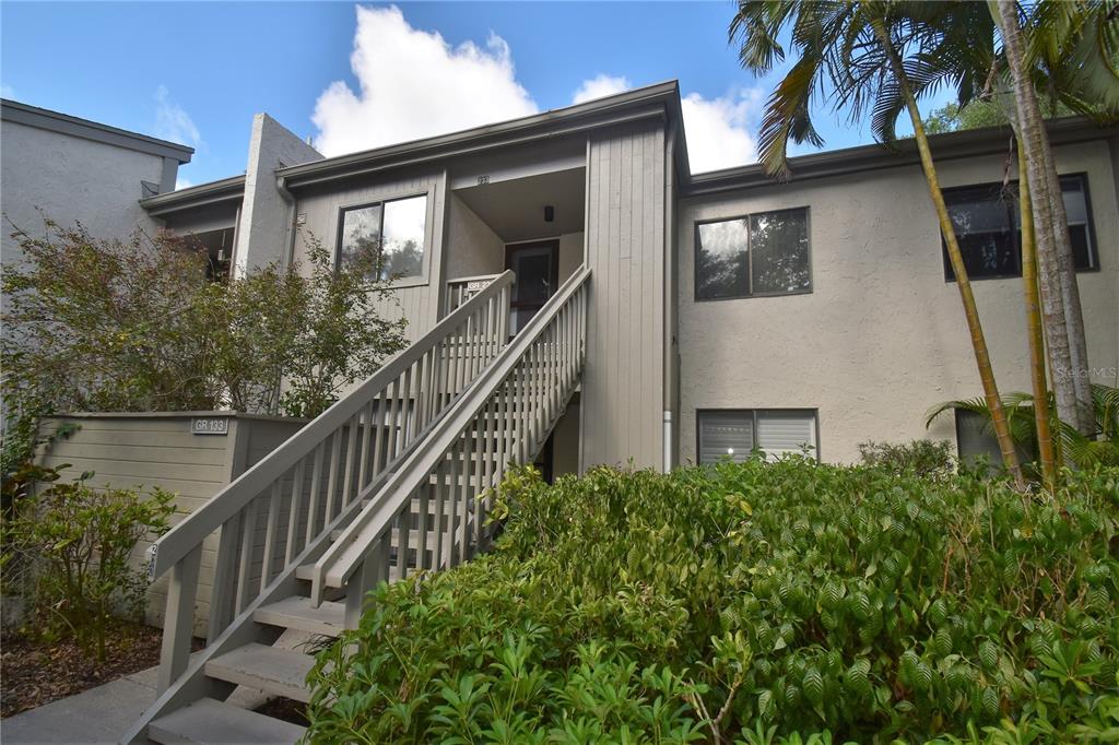 1508 Pelican Cove Road, Unit GR233 Sarasota, FL 34231 - Photo 2 of 37 a house view with a garden space