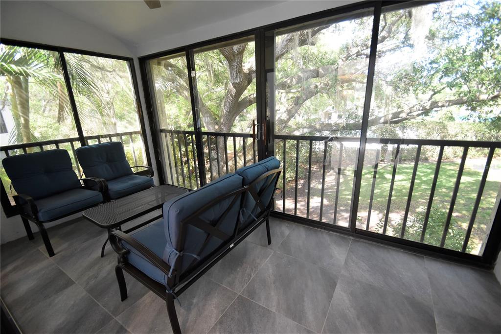 1508 Pelican Cove Road, Unit GR233 Sarasota, FL 34231 - Photo 21 of 37 a living room with furniture and a large window