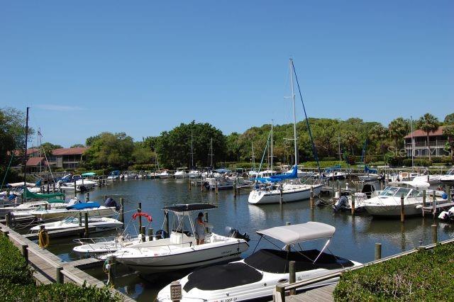 1508 Pelican Cove Road, Unit GR233 Sarasota, FL 34231 - Photo 27 of 37 a view of a lake with chairs