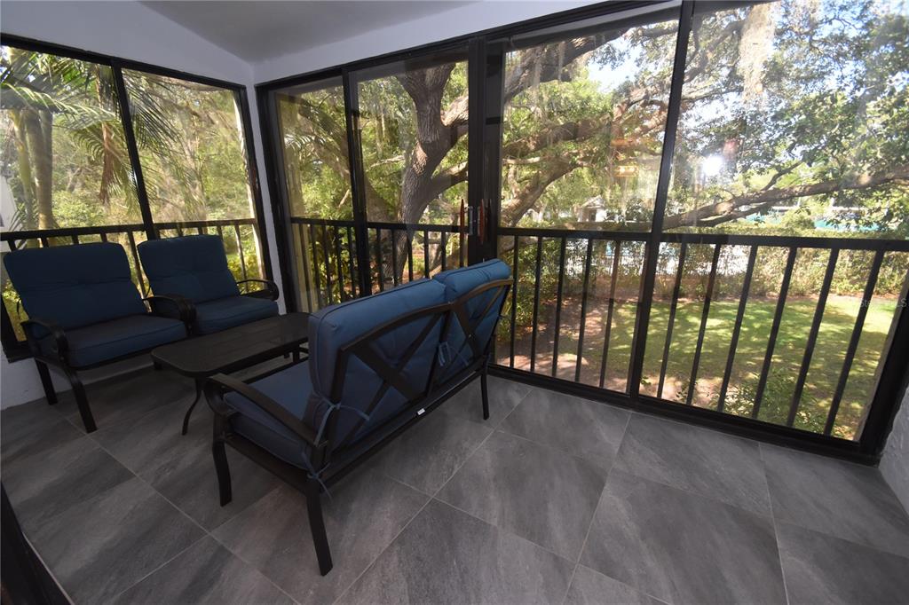 1508 Pelican Cove Road, Unit GR233 Sarasota, FL 34231 - Photo 5 of 37 a view of a living room with furniture and a floor to ceiling window