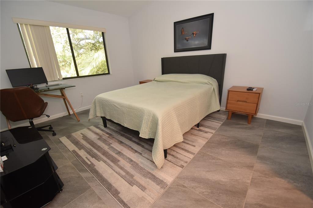 1508 Pelican Cove Road, Unit GR233 Sarasota, FL 34231 - Photo 6 of 37 a bedroom with a bed and window
