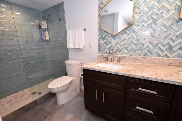 a bathroom with a sink toilet and shower