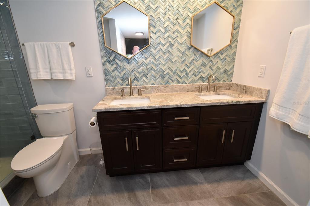 1508 Pelican Cove Road, Unit GR233 Sarasota, FL 34231 - Photo 9 of 37 a bathroom with a sink and a mirror