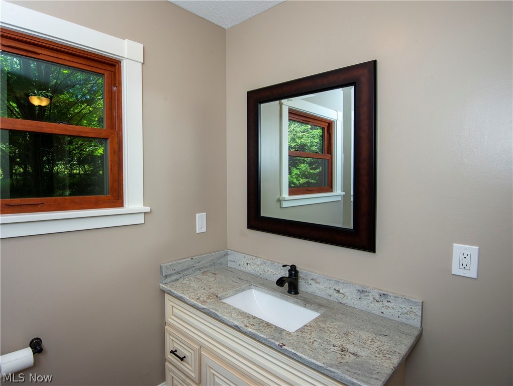 17015 Ravenna Road Chagrin Falls, OH 44023 - Photo 18 of 34 Guest bath remodeled with new paint, floors, sink, granite and cabinet.