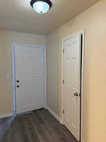an empty room with wooden floor and closet