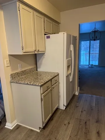 a kitchen with a refrigerator sink and cabinets