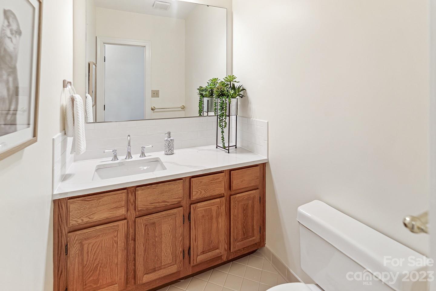 1601 South Wendover Road Charlotte, NC 28211 - Photo 13 of 43 a bathroom with a sink a toilet and a mirror