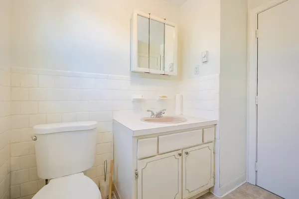 a bathroom with a sink a toilet and a mirror
