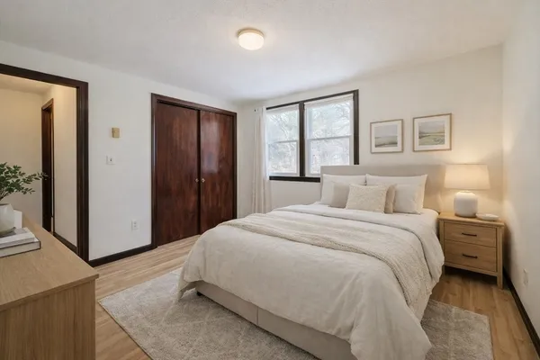 a spacious bedroom with a bed and a window