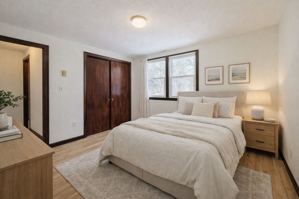 67 Blackstone Street, Unit 67 Bellingham, MA 02019 - Photo 17 of 25 a spacious bedroom with a bed and a window