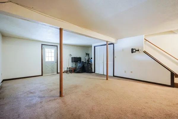a view of a big room with closet and windows