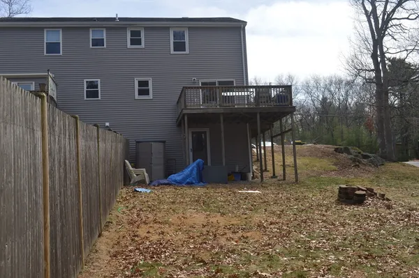 a view of a house with backyard and porch