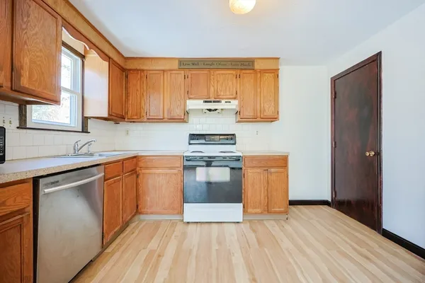 a kitchen with stainless steel appliances granite countertop a stove and a sink