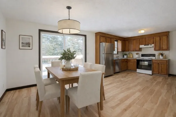 a view of a dining room with furniture window and wooden floor