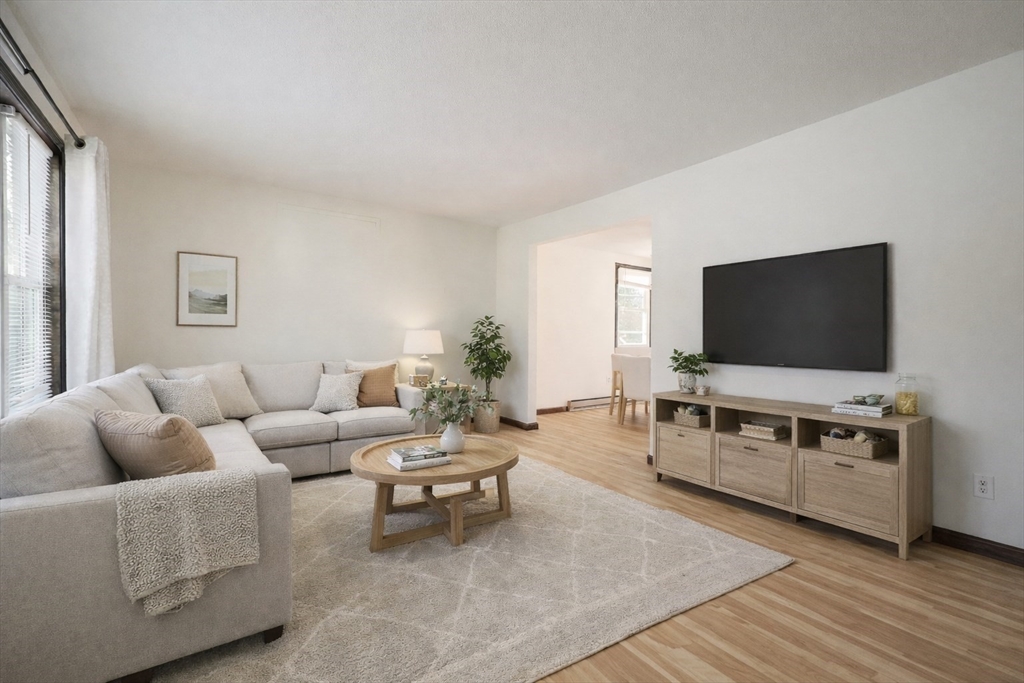 67 Blackstone Street, Unit 67 Bellingham, MA 02019 - Photo 9 of 25 a living room with furniture and a flat screen tv