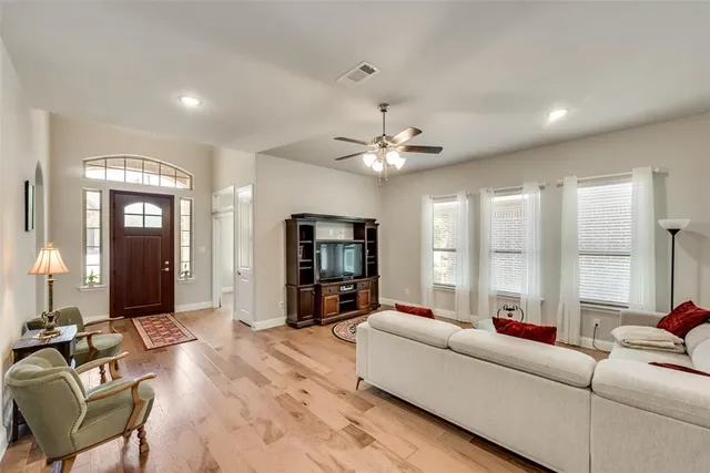 a living room with furniture and a large mirror
