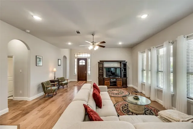 a kitchen with stainless steel appliances granite countertop a stove top oven a refrigerator a sink and dishwasher a oven with white cabinets